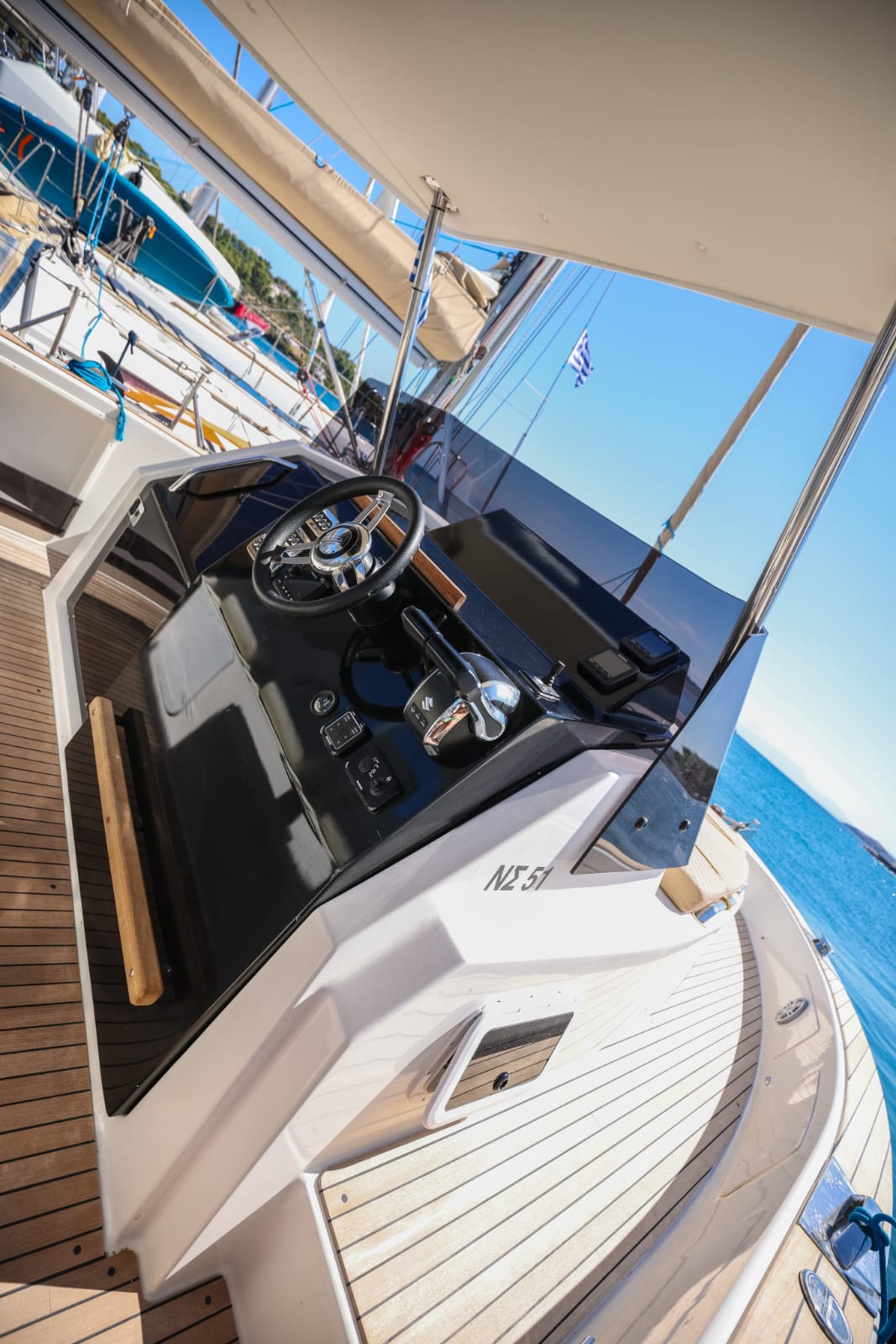 Yacht's dining area set for gourmet meal with ocean backdrop