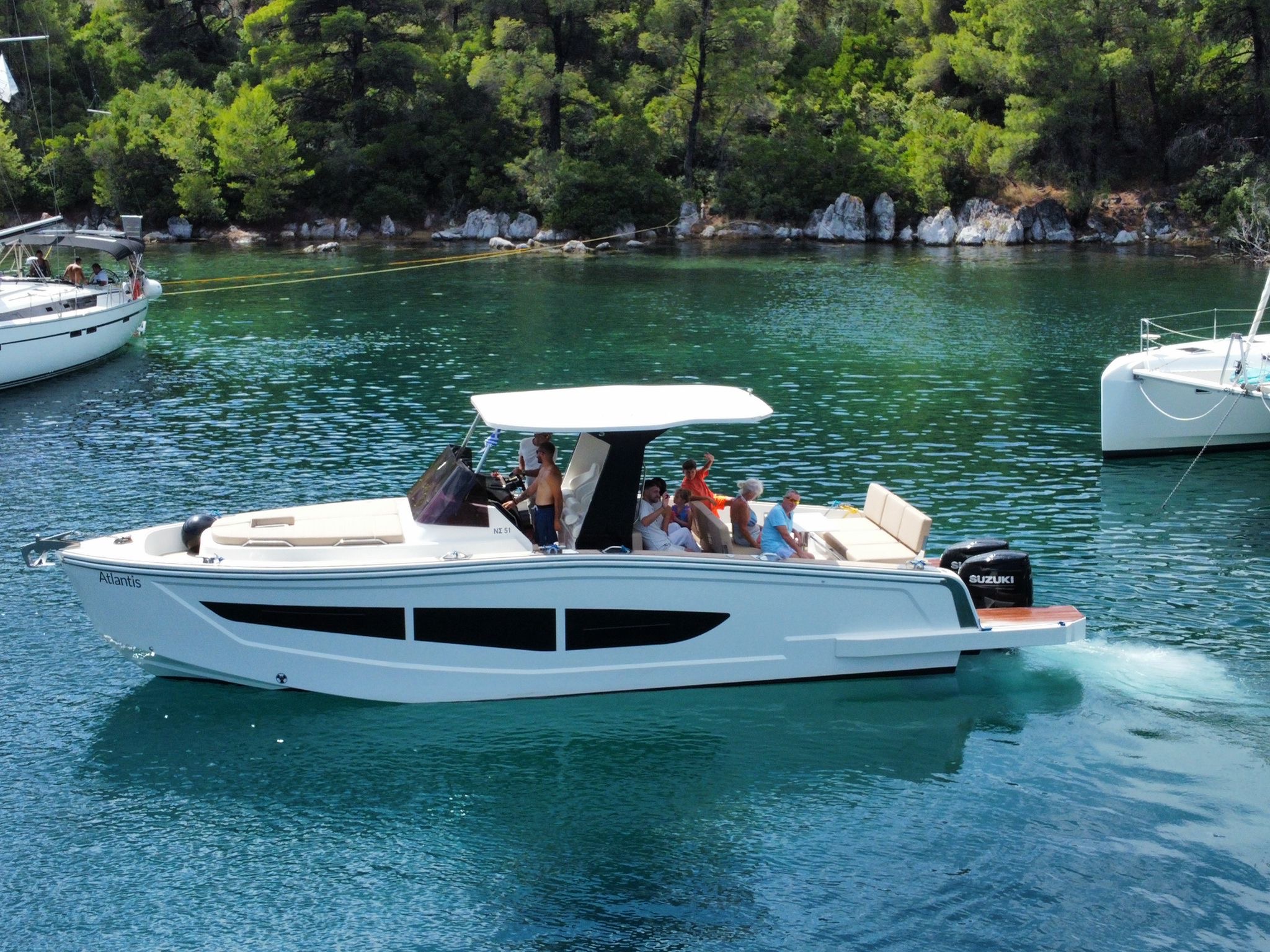 Guests enjoying sunset cocktails on yacht's upper deck
