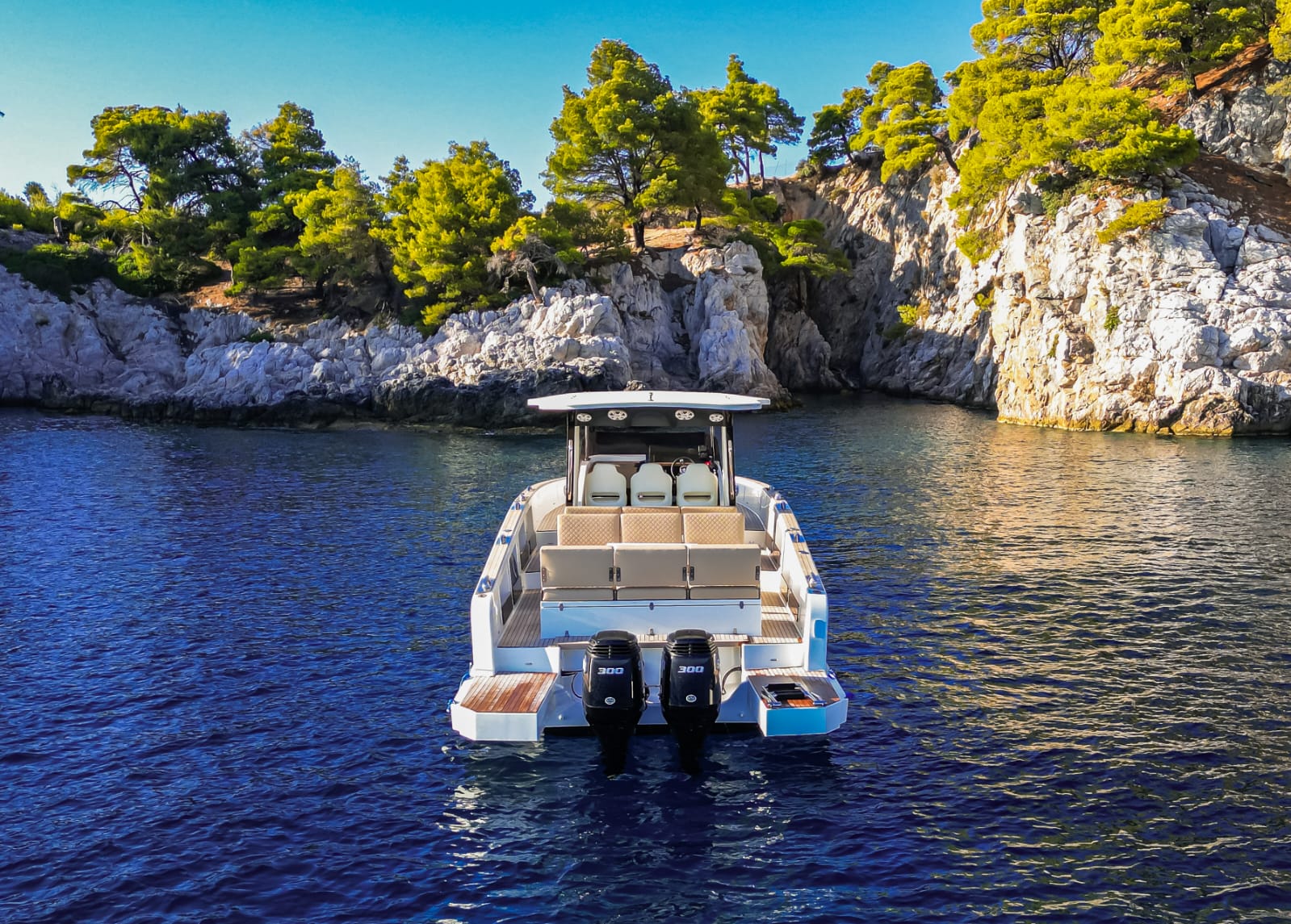 Yacht cruising through calm blue waters near Greek coastline